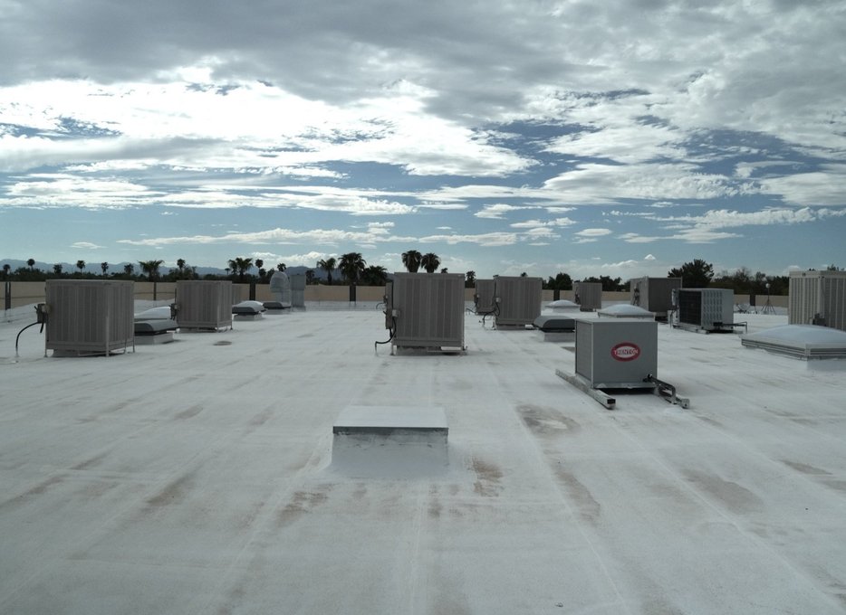 Row of rooftop HVAC units across a multi-tenant commercial roof