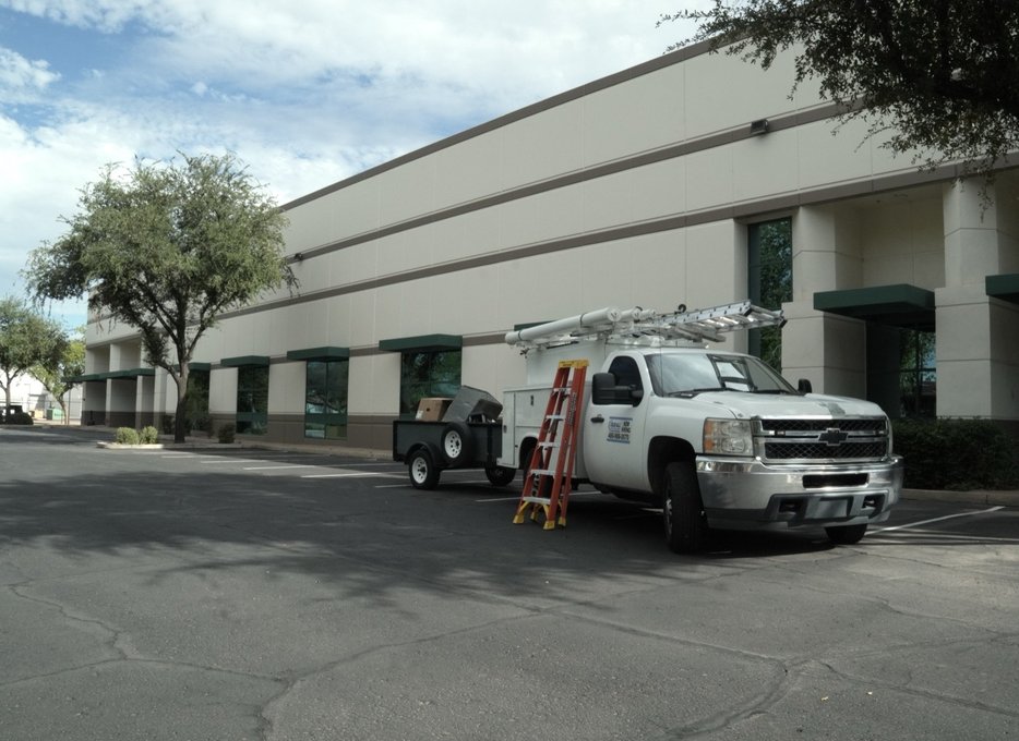 Due-All service truck parked at a commercial building