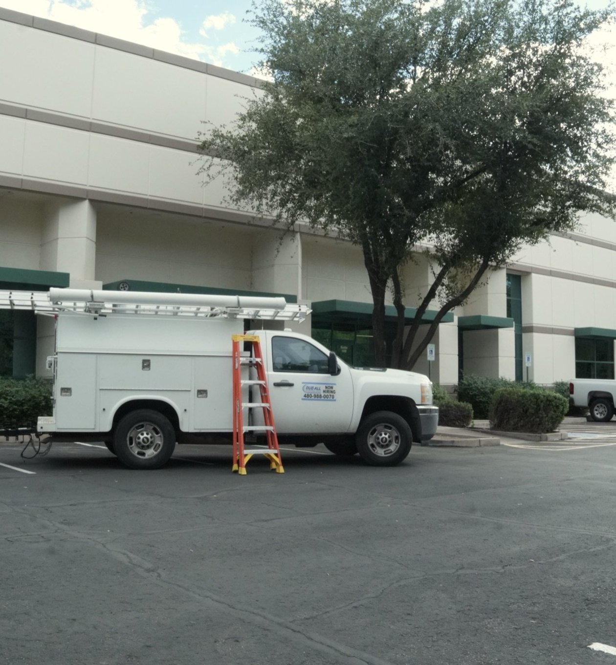 Due-All service truck parked at a managed commercial site