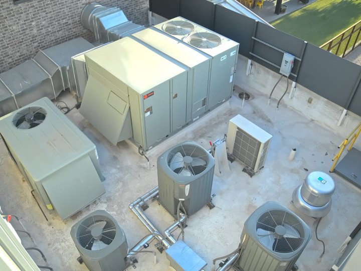 Rooftop condensers and package unit on a new commercial building