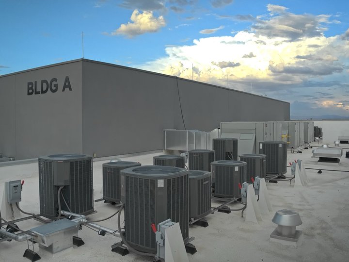 Bank of split system condensers on a commercial roof