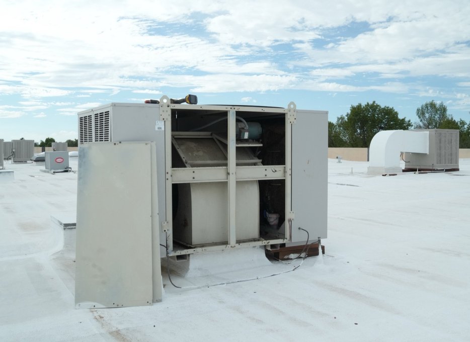 Commercial swamp cooler on a roof with the service panel off