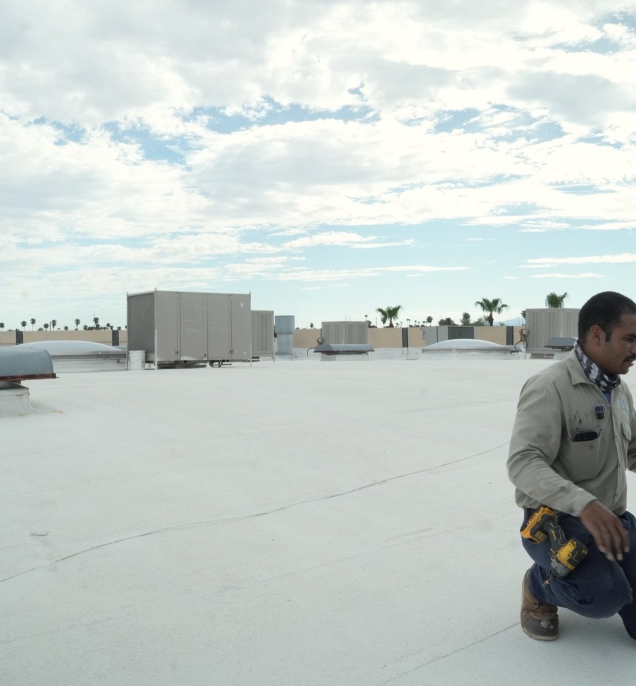 Due-All technician servicing a large packaged rooftop unit