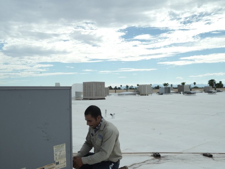 Due-All technician checking a rooftop unit