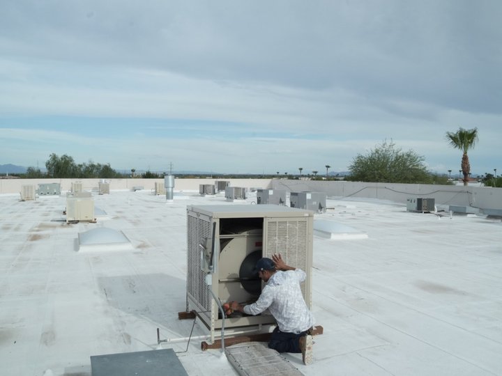 Due-All technician servicing a commercial swamp cooler