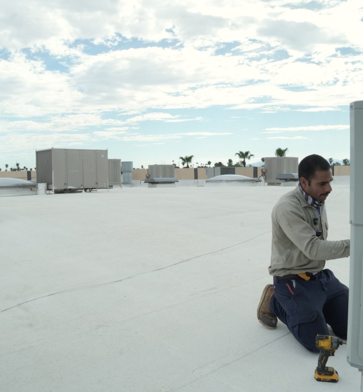 Due-All technician servicing equipment on a managed commercial property